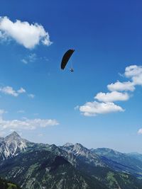 Man doing paragliding against sky