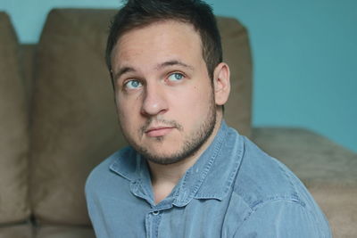 Portrait of young man at home