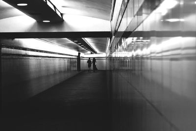 People walking in illuminated building