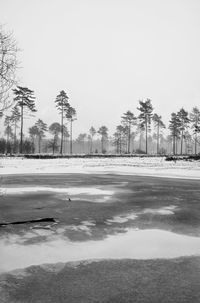 Scenic view of frozen lake against sky during winter