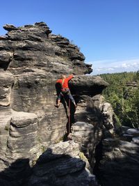 Full length of person on rock against sky