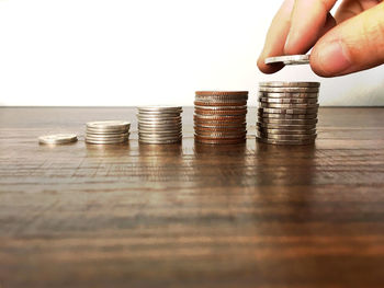 Cropped image of hand holding stack of table