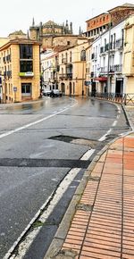 Road by buildings in city