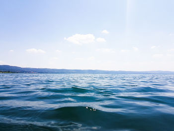 Scenic view of sea against sky on sunny day