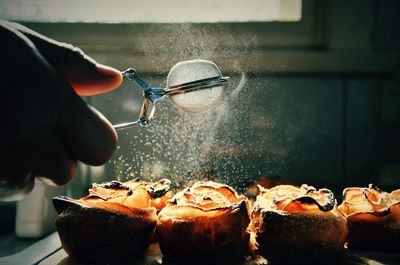 Cropped image of hand preparing apple pastry