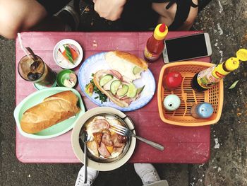High angle view of hand holding food on table