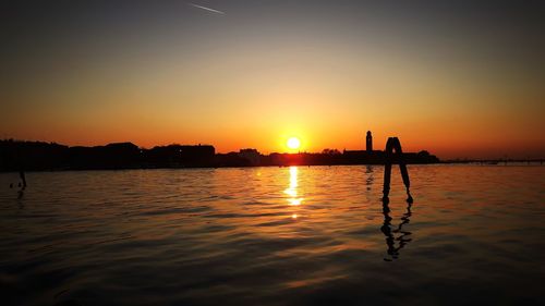 Scenic view of lagoon against sky during sunset in venice