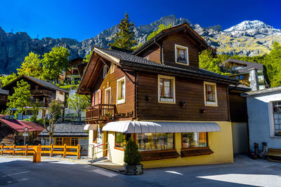 Houses by street and buildings against sky