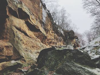 Low angle view of rock formation on mountain against sky