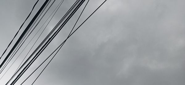 Low angle view of electricity pylon against sky