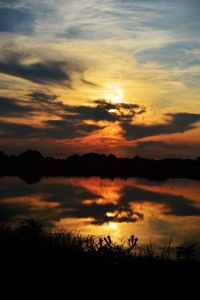 Scenic view of orange sky reflection in lake during sunset