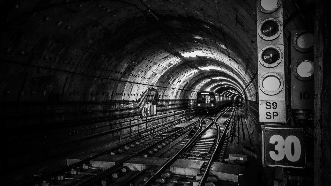 TRAIN IN ILLUMINATED RAILROAD STATION