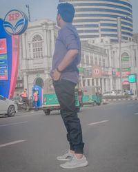 Full length of man standing on street in city