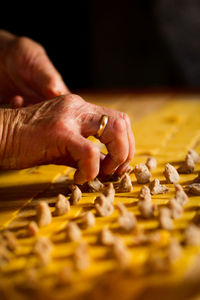 Cropped hands preparing food at table