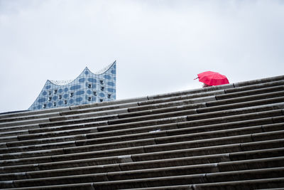 Low angle view of staircase in city against sky