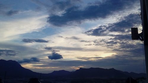 Low angle view of silhouette mountains against sky at sunset