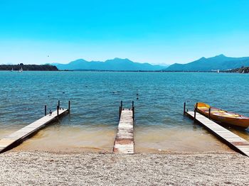 Scenic view of lake against clear blue sky