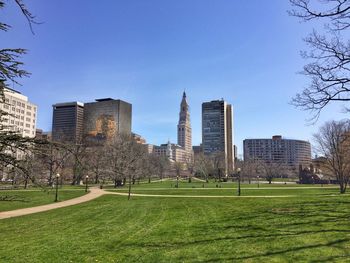 Buildings in city against clear sky