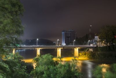 Bridge over river at night