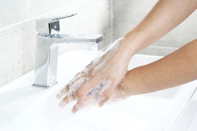 Low section of person in bathroom at home