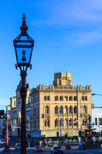 Buildings in city against blue sky