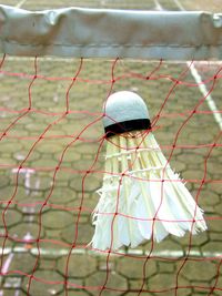 Close-up of shuttlecock on net