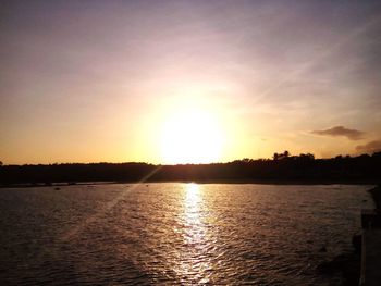 Scenic view of lake at sunset