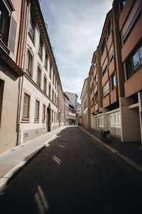 Road amidst buildings in city