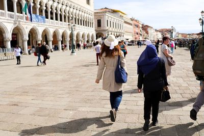 Group of people walking in town square