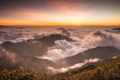 Scenic view of mountains against sky at sunset