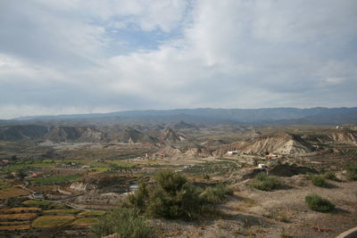 Scenic view of mountains against cloudy sky