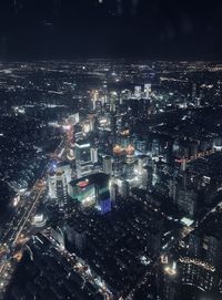 High angle view of illuminated city buildings at night