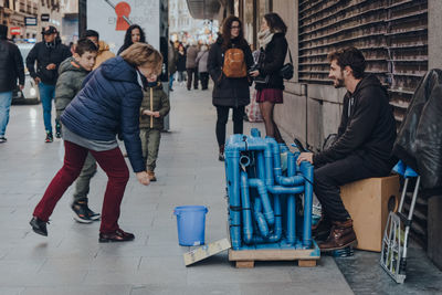 People walking on sidewalk in city