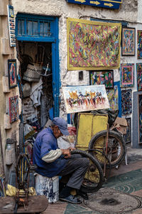 Man sitting at market stall