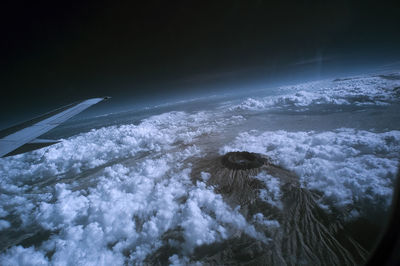 Aerial view of airplane wing over sea