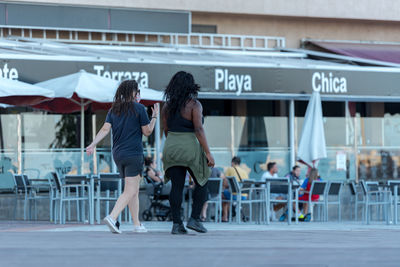 People walking on zebra crossing in city