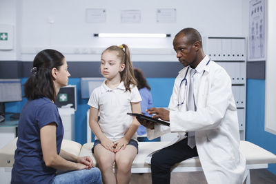 Female doctor examining patient at clinic