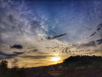 Scenic view of silhouette landscape against sky at sunset