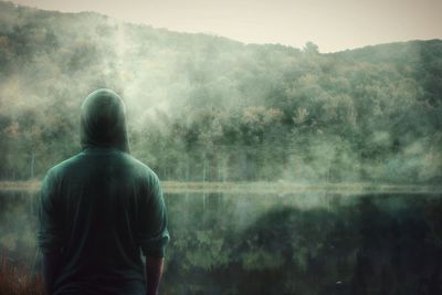 Rear view of man standing on countryside landscape