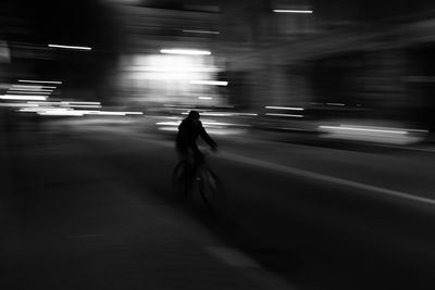 Blurred motion of man walking on road