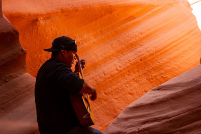 Rear view of man photographing