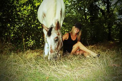 Young woman with horse in a field