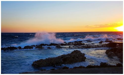 Scenic view of sea against clear sky during sunset