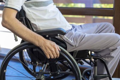 Midsection of man sitting in bus