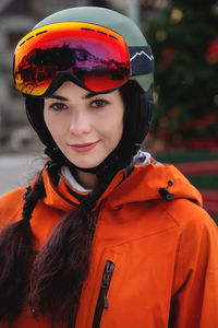 Portrait of a woman in the alps. young beautiful caucasian woman in ski goggles looking at the