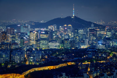 High angle view of illuminated buildings in city at night