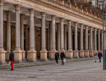 People walking in historical building