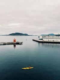 Canoeing in Ålesund harbor, aerial view with a great perspective on the horizon and the islands