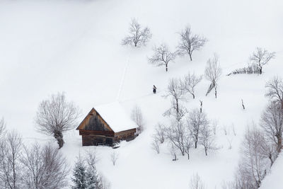 Built structure and trees against sky during winter