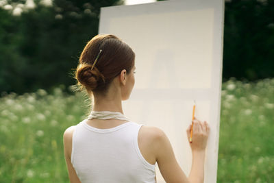 Rear view of woman standing outdoors